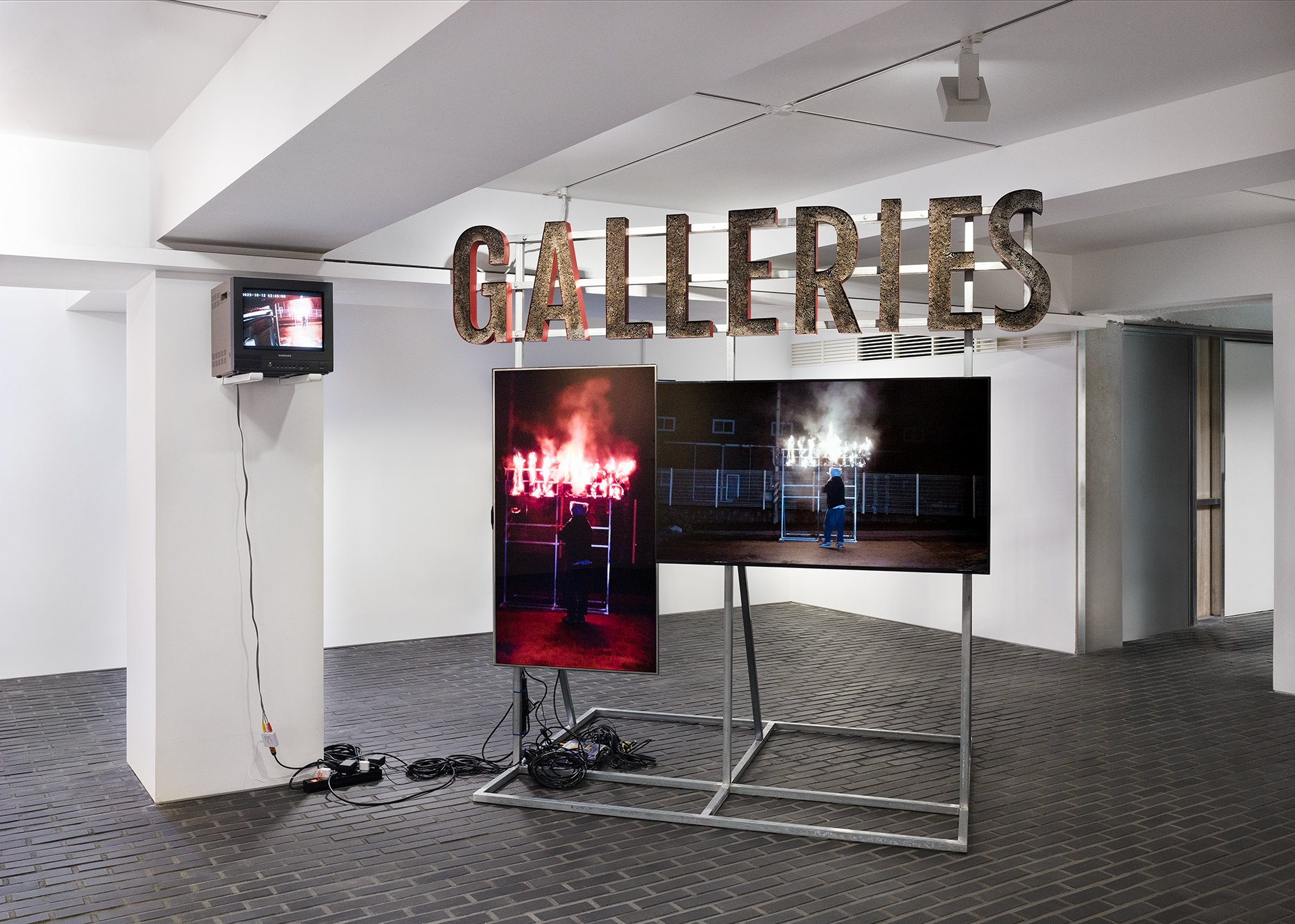 Burning Down the Galleries, 2025, Steel frame, approx. 46,000 matches, 3-channel video, 4 min. 56 sec., 160 × 230 × 230 cm