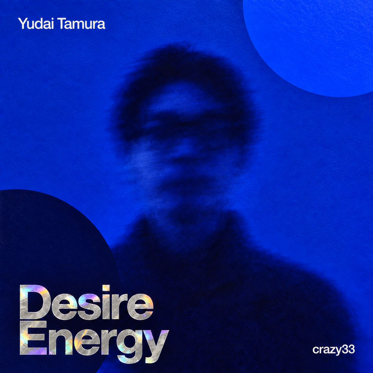 Yudai Tamura『Desire Energy』。本人写真を青く変形した別作品のジャケット。